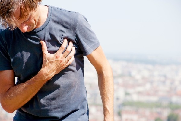 image of man clutching his chest